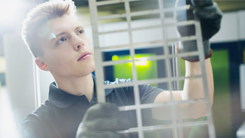 Man looking at laser cut materials